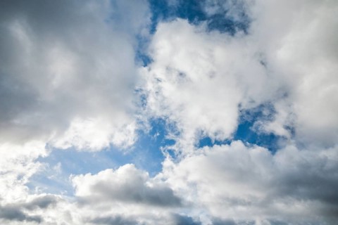 Stratocumulus clouds and blue sky windows form spectacular cloud formation in the sky during Foehn storm