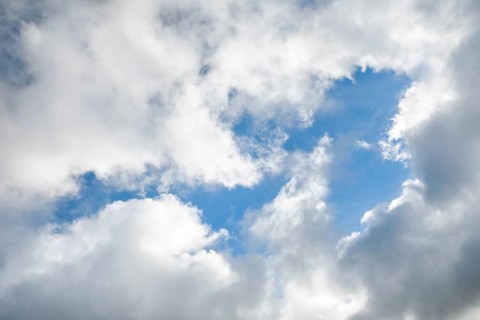 Stratocumulus clouds and blue sky windows form spectacular cloud formation in the sky during Foehn storm