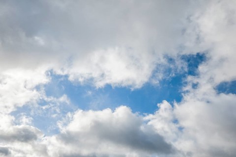 Stratocumulus clouds and blue sky windows form spectacular cloud formation in the sky during Foehn storm