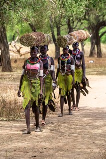 Girls with collected reeds on their heads on their way home