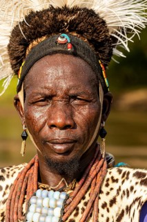 Man from the Toposa tribe posing in his traditional warrior costume