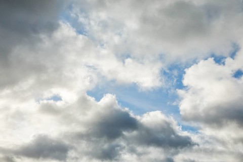 Stratocumulus clouds and blue sky windows form spectacular cloud formation in the sky during Foehn storm
