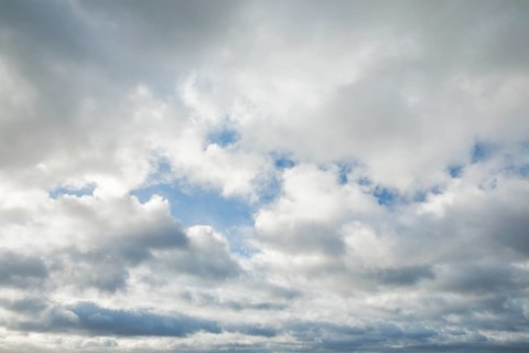 Stratocumulus clouds and blue sky windows form spectacular cloud formation in the sky during Foehn storm