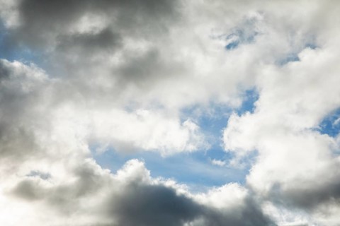 Stratocumulus clouds and blue sky windows form spectacular cloud formation in the sky during Foehn storm