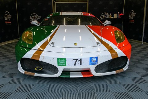 Ferrari F430 in Italian national flag design stands in pit in pit lane