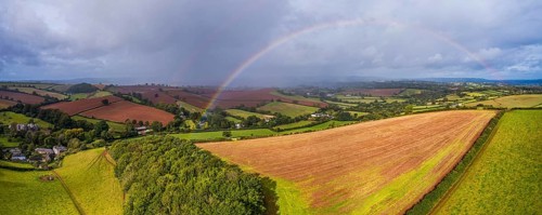 Rainbow over the Fields over Compton Castle from a drone