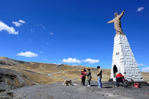 Ceremony with a shaman at the statue of Jesus at La Cumbre Pass