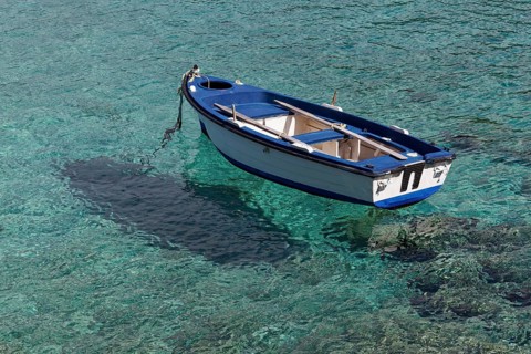 Rowing boat in crystal clear water