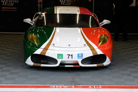 Ferrari F430 in design of Italian national flag stands in pit in pit lane