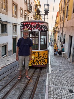 Man standing on rails in front of funicular