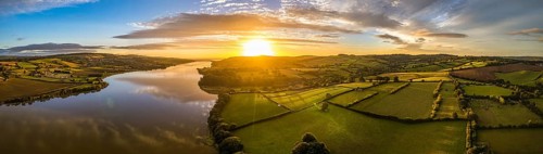 Panorama of Sunrise over Fields and River Teign from a drone