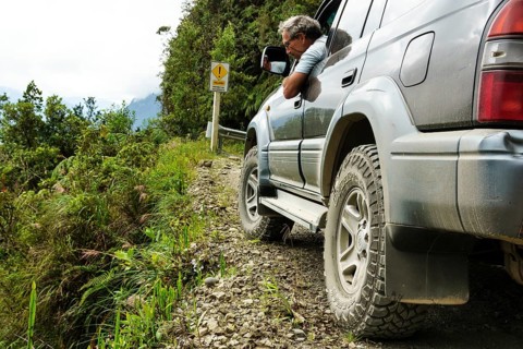 Driver checks the road in an off-road vehicle