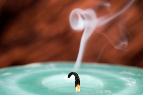 Still smoking candle wick
