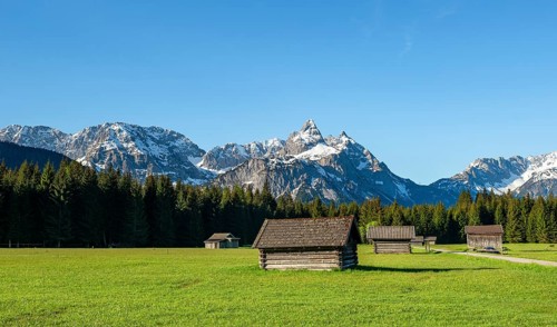 Meadow with hay barns