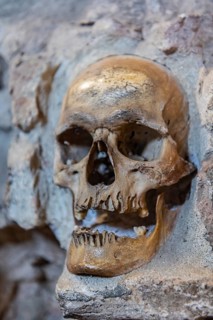 Stone structure embedded with human skulls