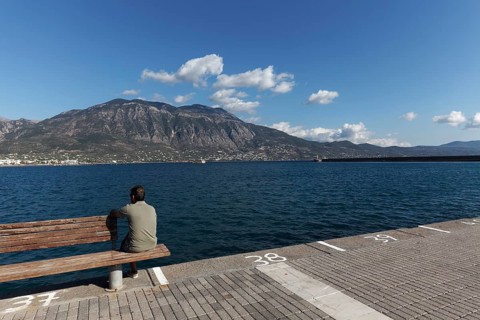 Man sitting on a bench at the pier