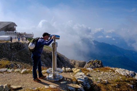 Hiker with telescope at the summit of Lagazuoi