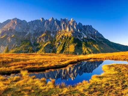 Mandl walls reflected in a mountain lake