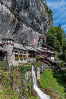 Ensemble of buildings with waterfall in front of the Saint Beatus Caves