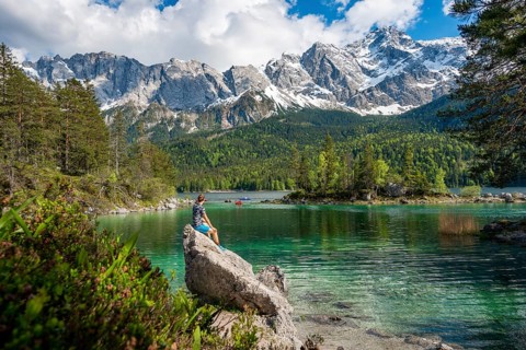 Young man sitting on a rock