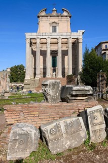 Historic facade of Temple of Pius and Faustina with staircase and ancient columns