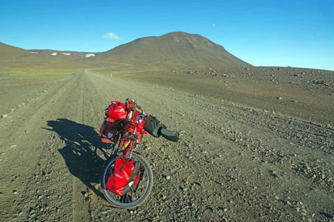 Loaded bicycle on rough track in barren