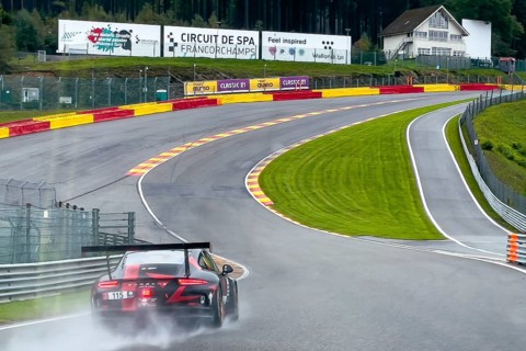 Porsche GT3 Cup race car hits wet track at Eau Rouge corner from Raidillon slip road