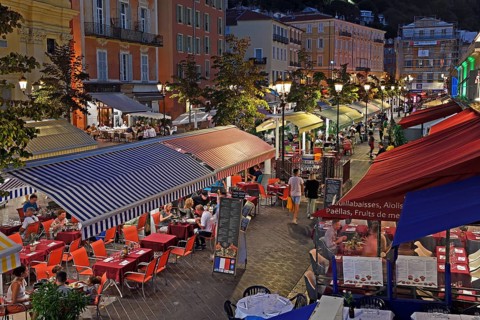 Evening hustle and bustle with restaurants and market stalls on the Cours Saleya