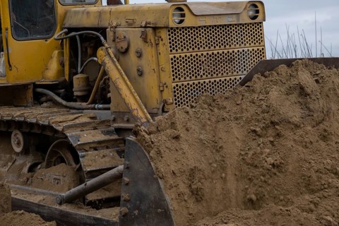 Bulldozer removes dam in the delta Danube river