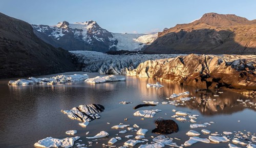Glacial river in front of Mountains with Hvannadalshnukur