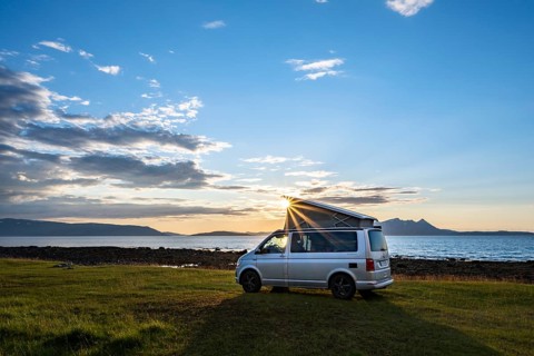 Camper standing by fjord