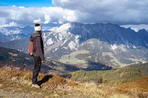 Woman looking at the mountain group Leoganger Steinberge
