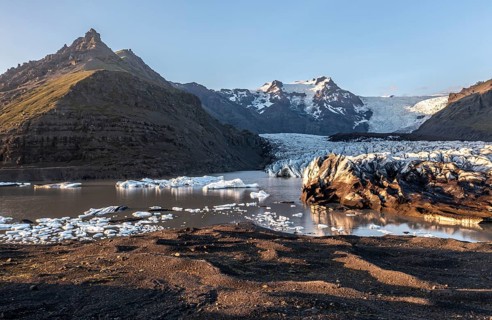 Glacial river in front of Mountains with Hvannadalshnukur