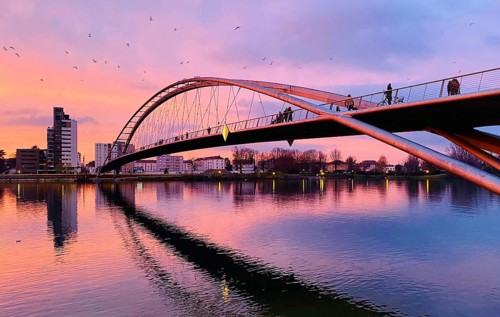 Three-country bridge at sunset towards France