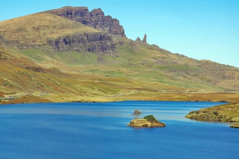Small island in the loch and prominent rocks and mountains