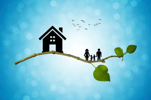 Tree branch with silhouettes of house and family