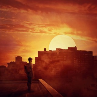 Young boy stay on the rooftop looking at the sunset