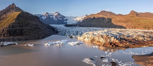 Glacial river in front of Mountains with Hvannadalshnukur