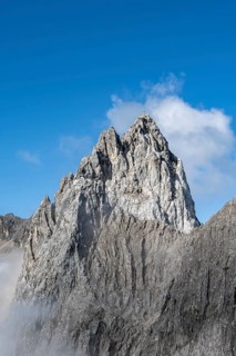 Rocky mountain peak with summit cross