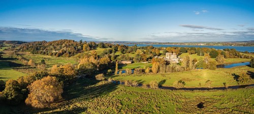 Panorama over Powderham Castle and Park from a drone in Autumn Colors