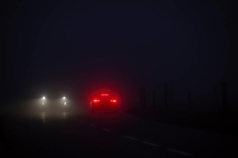 Cars in night and fog oncoming traffic