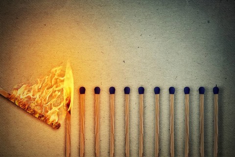 Burning match setting fire to its whole neighbors