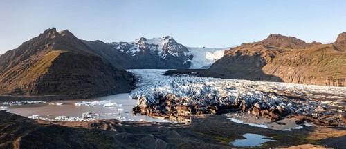 Glacial river in front of Mountains with Hvannadalshnukur