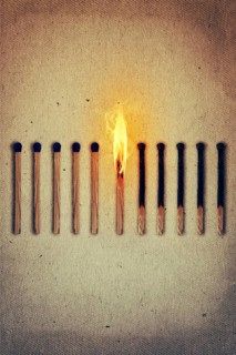 Burning match standing middle a row of whole