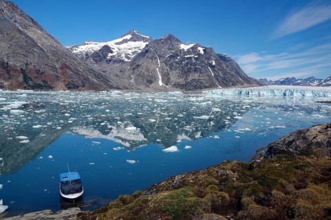 Small boat in the calm waters of a fjord