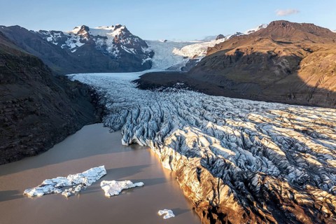 Glacial river in front of Mountains with Hvannadalshnukur