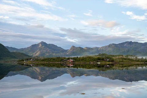 Mountains reflected in fjord near Laukvik