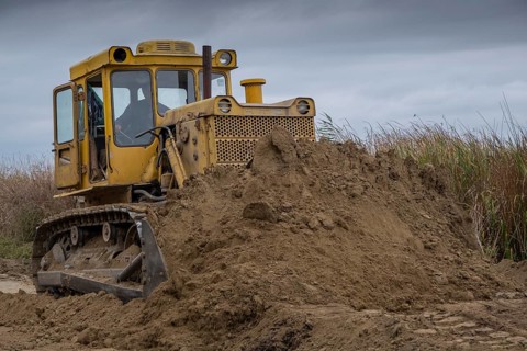 Bulldozer removes dam in the delta Danube river