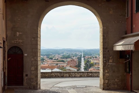 Gate of the city wall of the old town of Castiglione del Lago with view of the new town