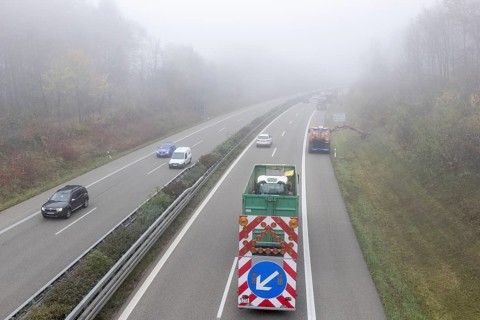 Escort vehicle for protection during mowing work on motorway in autumn